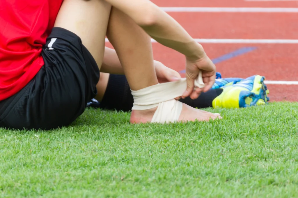 5 Essential Treatments For Sports Injuries Manchester Athletes Face: Your Complete Guide To Sports Injury First Aid 2 athlete ankle injury with a bandage