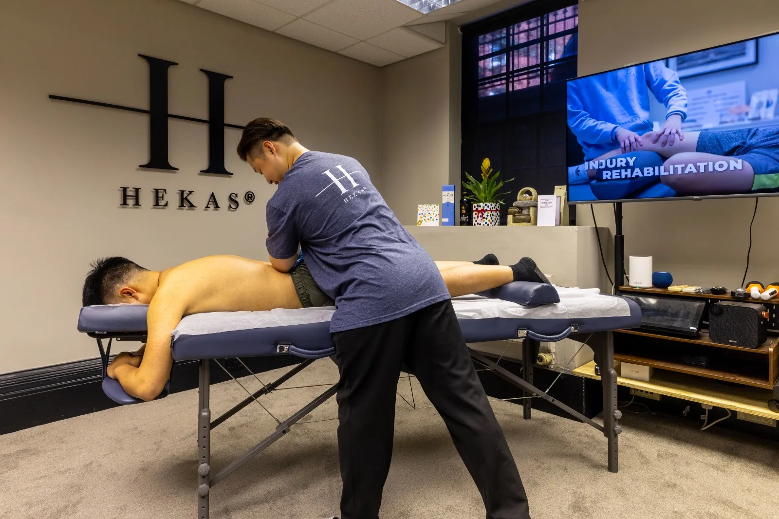 Sylar working performing intensive back sports massage on a client for his health