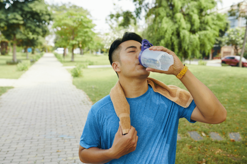 man drinking water to stay hydrated and trying to reduce calf cramps