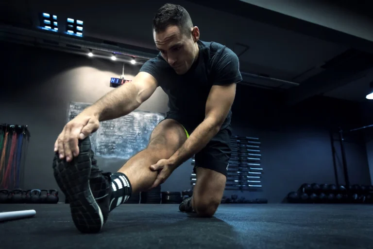 man stretching at the gym