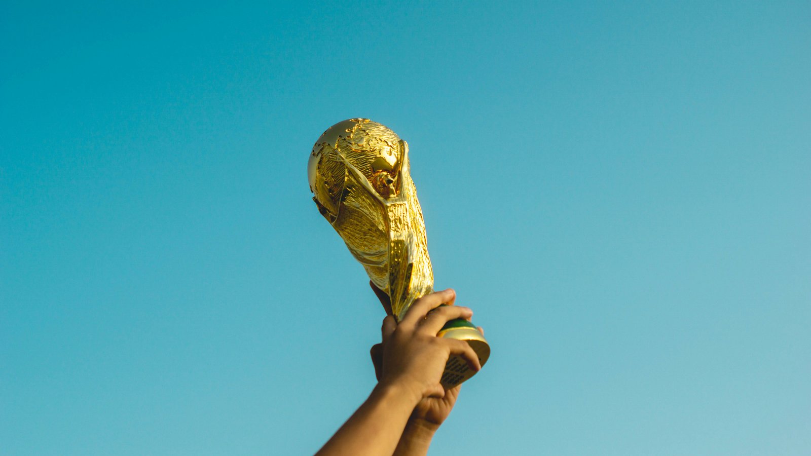 Congratulations Spain! What World Cup Heroes Can Teach Us About Off-Season Recovery & Injury Prevention 1 Spain fans celebrating World Cup victory with trophy raised at stadium